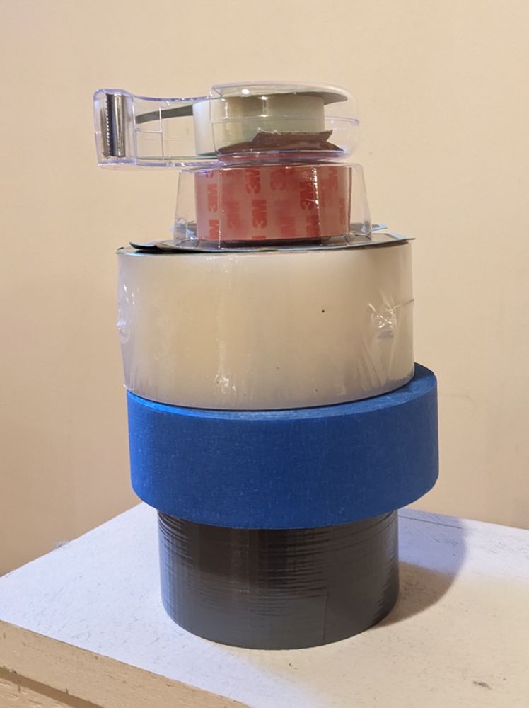 a stack of 5 tape rolls: duck, painters, weather seal, double sided mounting, and classic little clear in dispenser.