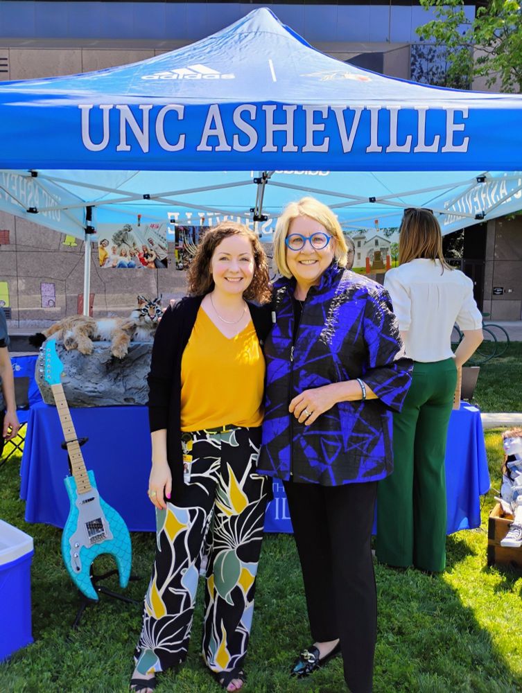 NC House Representative Lindsey Prather (left) pictured with the UNC-Asheville Chancellor Dr. Kimberly van Noort (right) in front of a blue UNC-Asheville tent.