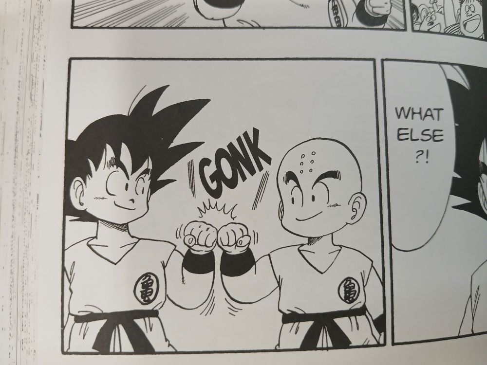 a panel from chapter 125 of Dragon Ball, Goku and Kuririn hitting a fist bump before their fight