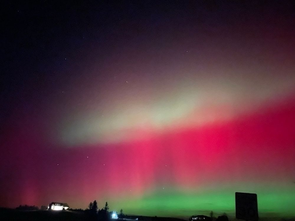 Aurora borealis showing green, pink, and white bands 