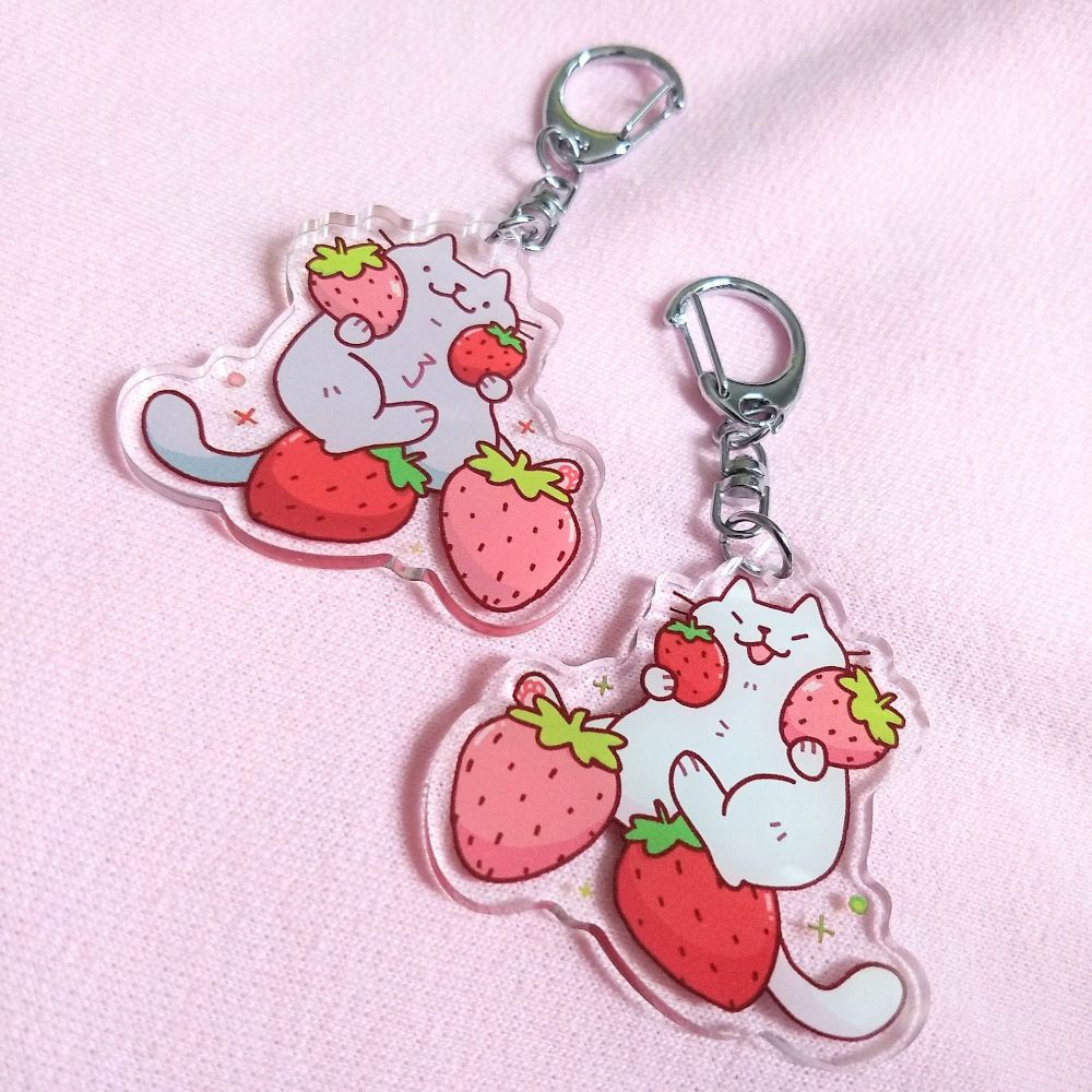 cats holding strawberries keychains