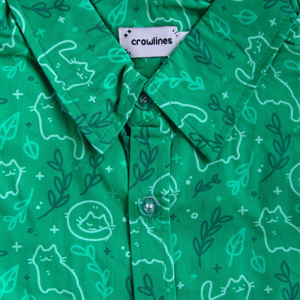 Dark green button up shirt patterned with cats and leaves