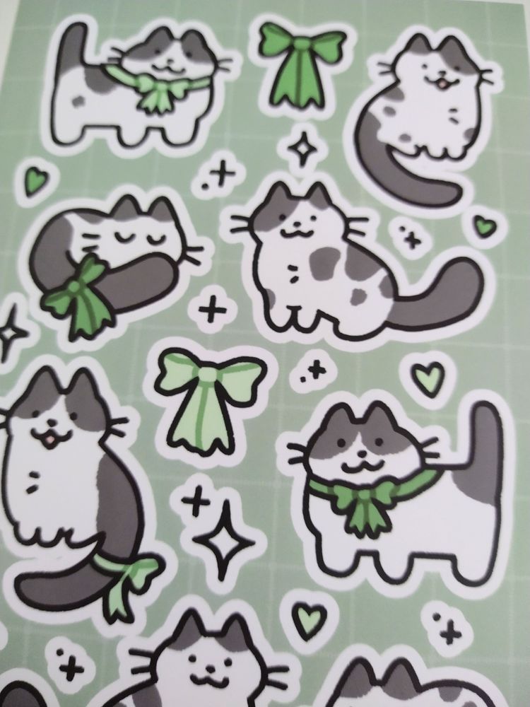 sticker sheet of cow cats wearing cute green ribbons