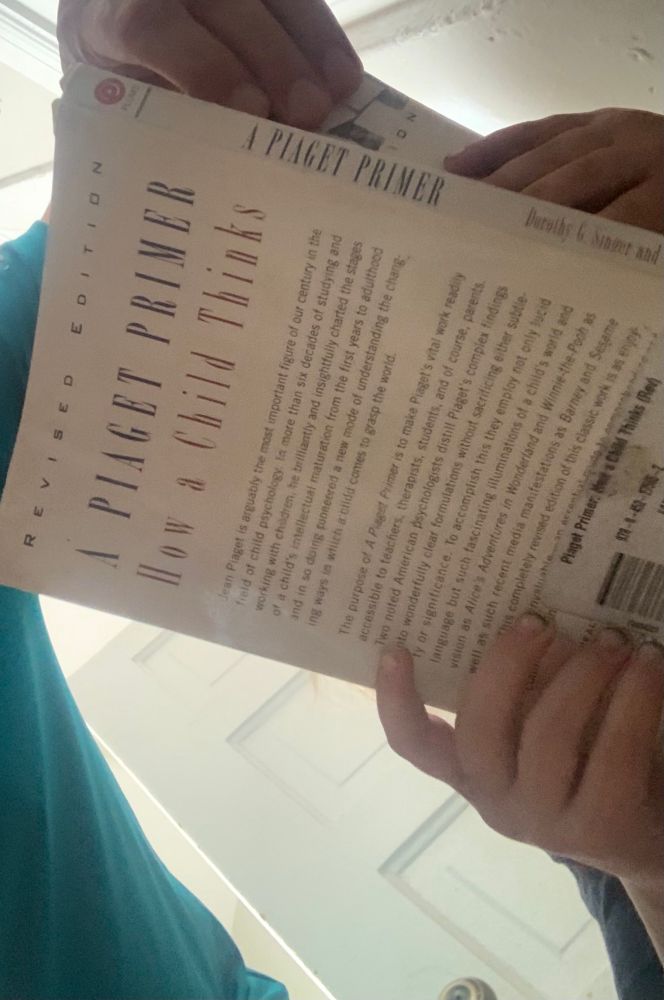 3yo reading A Piaget Primer, actually a childhood development textbook rather than a primer per se, during potty time