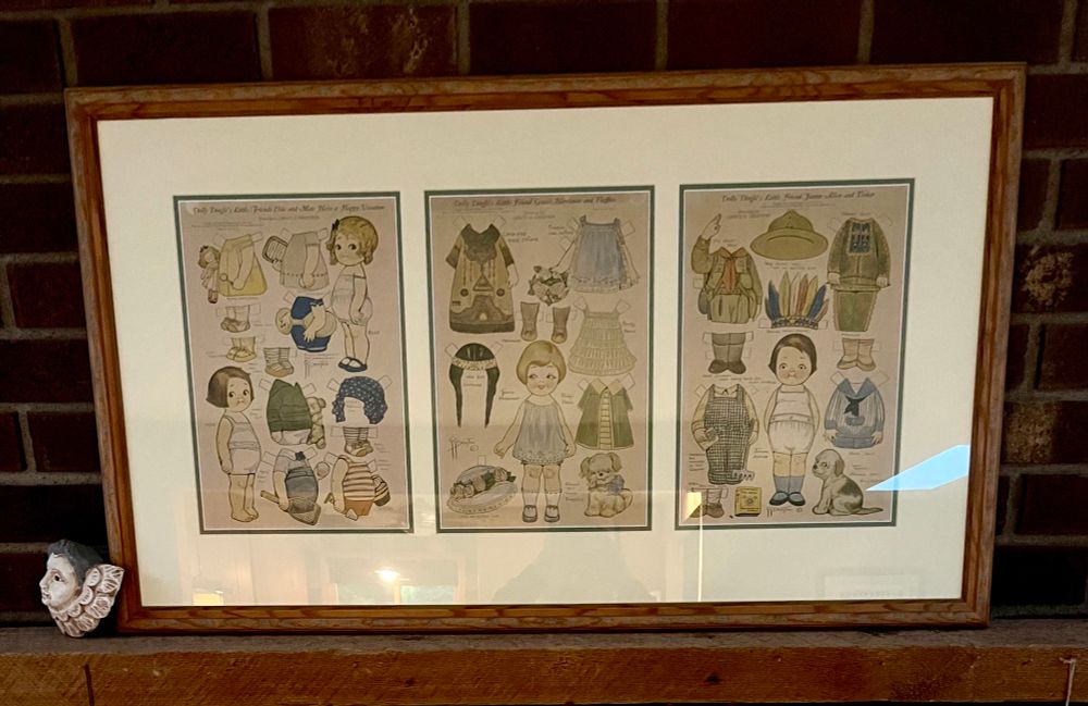 Photograph of framed uncut colored sheets of Dolly Dingle paper dolls by Grace Dayton 1878-1936. The Dolly Dingle paper dolls appeared in the magazine Pictorial Review which was published 1899-1939.