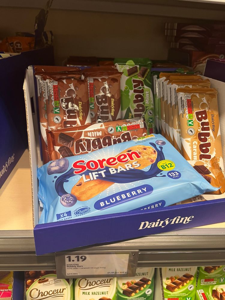 A supermarket shelf where a pack of Soreen lift bars has been deposited in the space where some bubbly chocolate lives