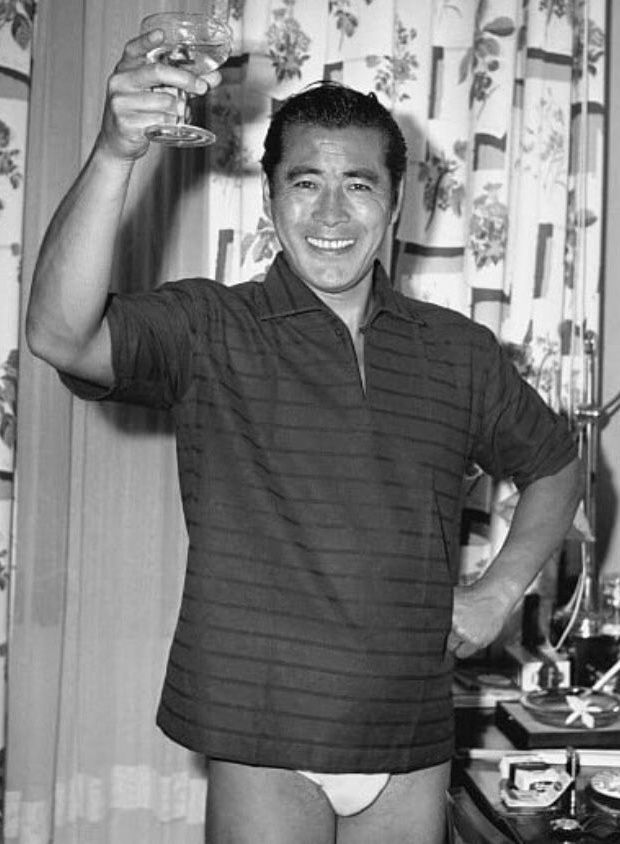 Actor Toshiro Mifune raising a toast in his underpants.