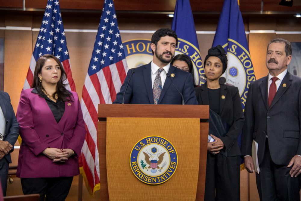 Congressman Casar speaks at a podium with other Progressive Caucus leaders.