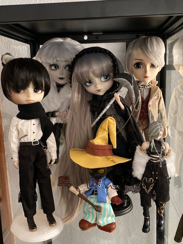 Most of my Pullip collection in a glass display cabinet, also featuring my custom Taeyang doll and my custom Vivi and The Past in Sicily dolls.