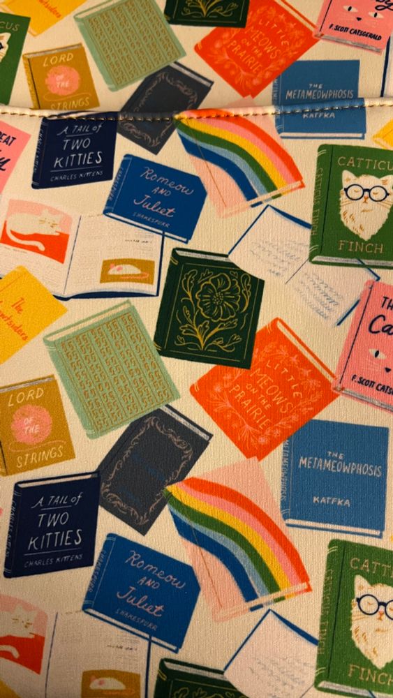 Book sleeve with parody book titles, like “tale of two kitties” and “the metameowphosis”