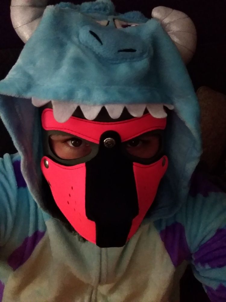 Human pup wearing a Sully from Monsters Inc. onesie