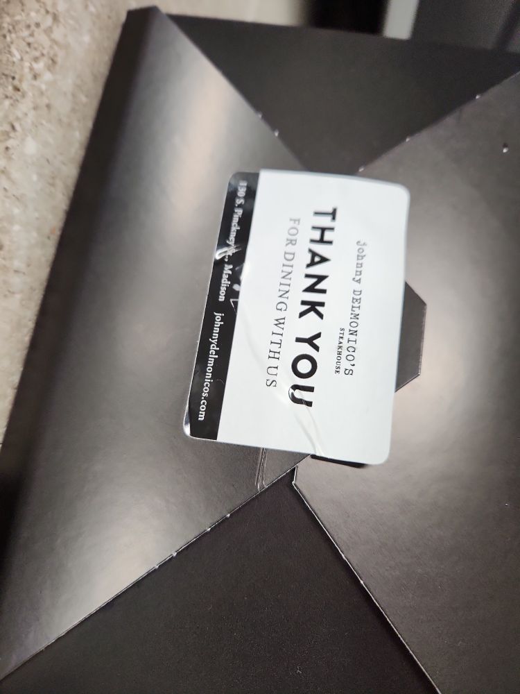 A close-up of the leftovers box showing where it came from: a steakhouse off the Capitol square in Madison Wisconsin