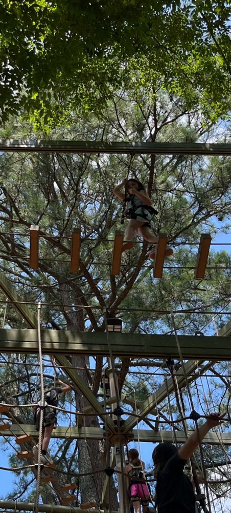 My daughter about 2 stories off the ground with on a ropes course. 