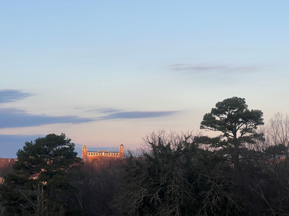 The setting moon with Old Main on the University of Arkansas campus.