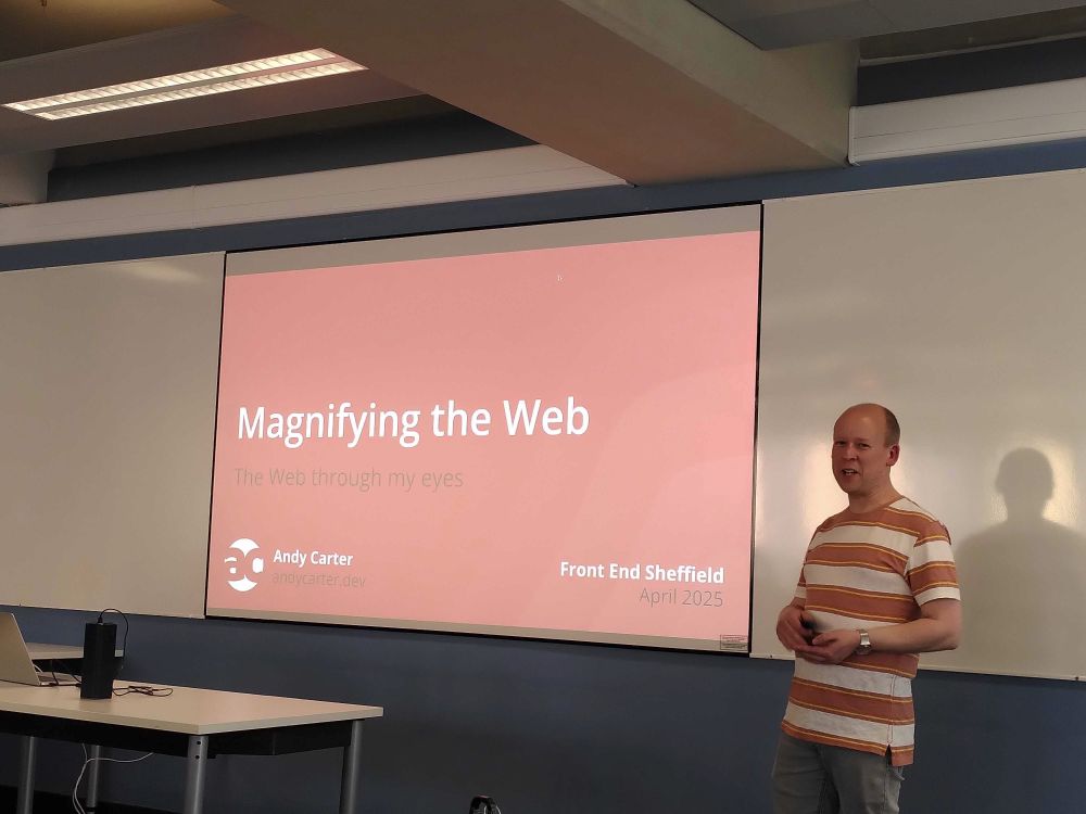 Andy standing in front of slide saying 'Magnifying the web'