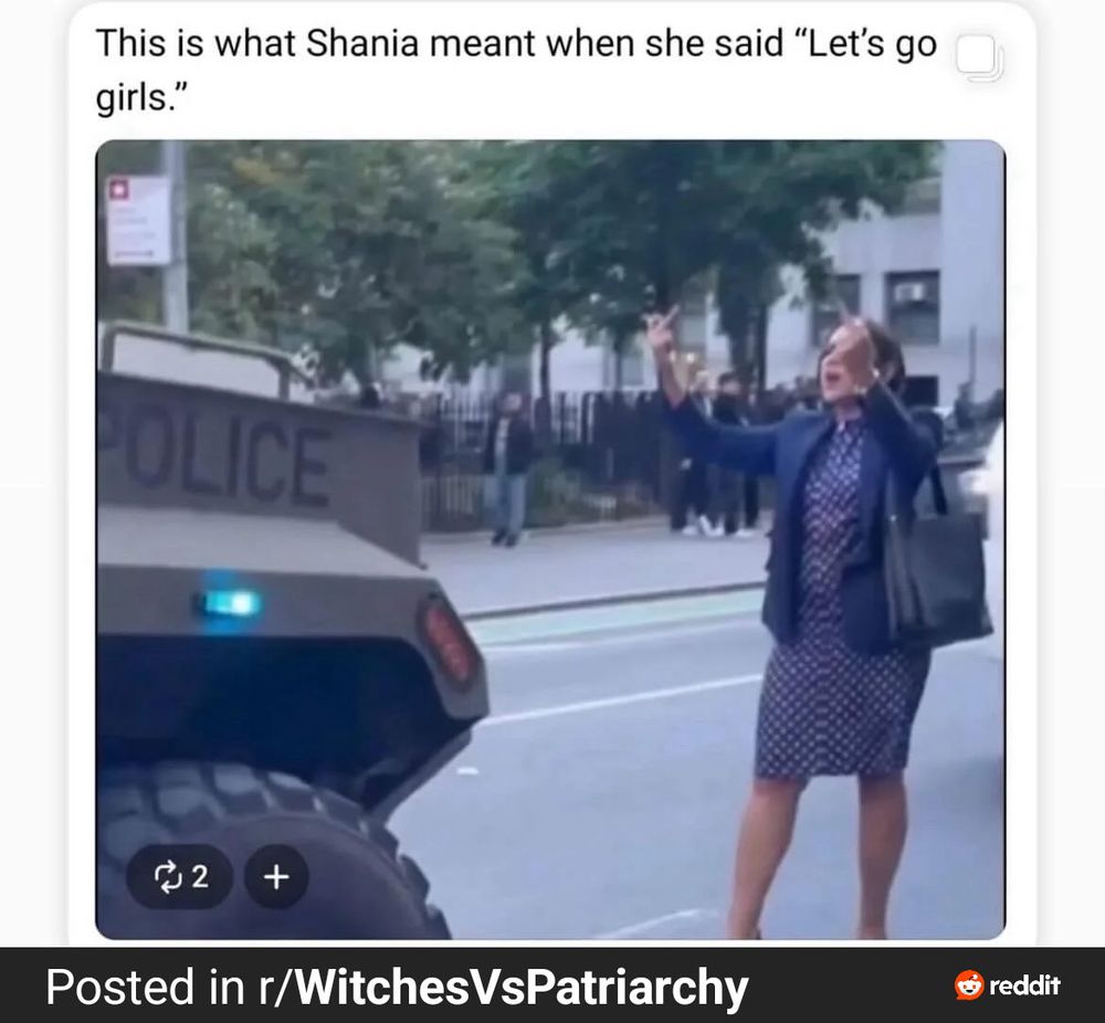 A woman standing alone, blocking the path of a humvee. She is a warrior in heels. 