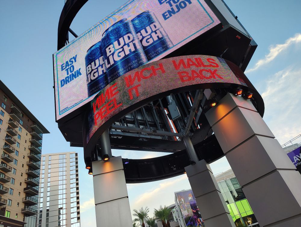 A rotating billboard advertising the Nine Inch Nails Peel It Back Tour