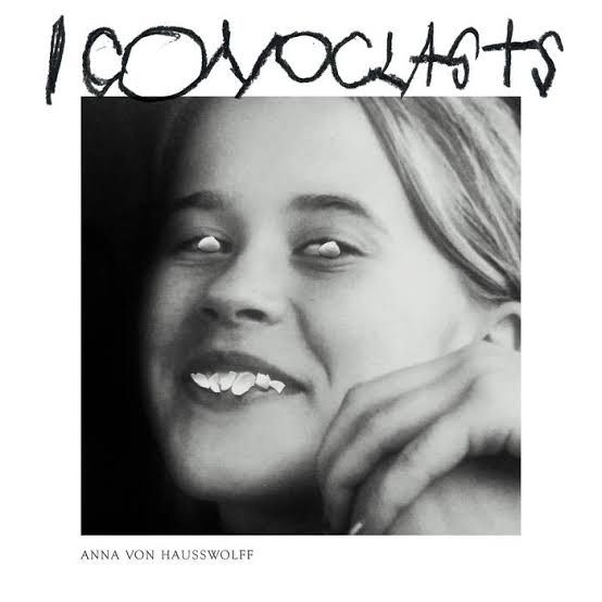 The cover for Anna Von Hausswolff's new album "Iconoclasts", featuring a black and white portrait of the artist with distorted eyes and teeth.