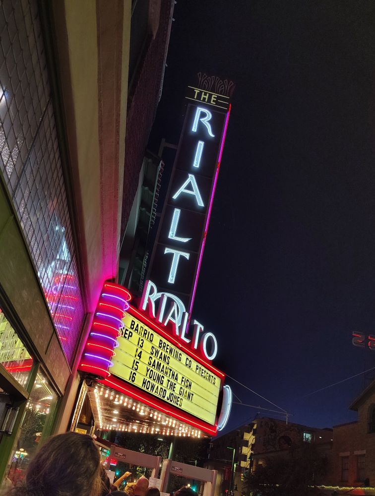 The neon marquee of The Rialto Theatre in Tucson, advertising "Sept. 13: Swans"