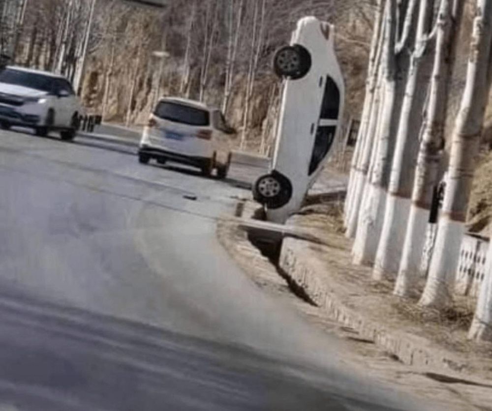 A car standing on it's front bumper in a vertical angle