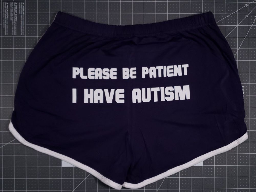 Booty shorts with "please be patient, I have autism" on the butt