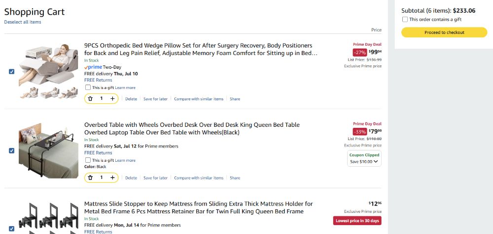 A screenshot of the poster's amazon cart, showing three of the six items they have, all on sale, and the total cost of the cart. The three items are an orthopedic support pillow set, an over-the-bed desk, and clamps that restrain the mattress on the frame. These items are needed for the poster to be able to move into bed-streaming fulltime due to disabilities preventing being able to sit in the chair for long hours. 