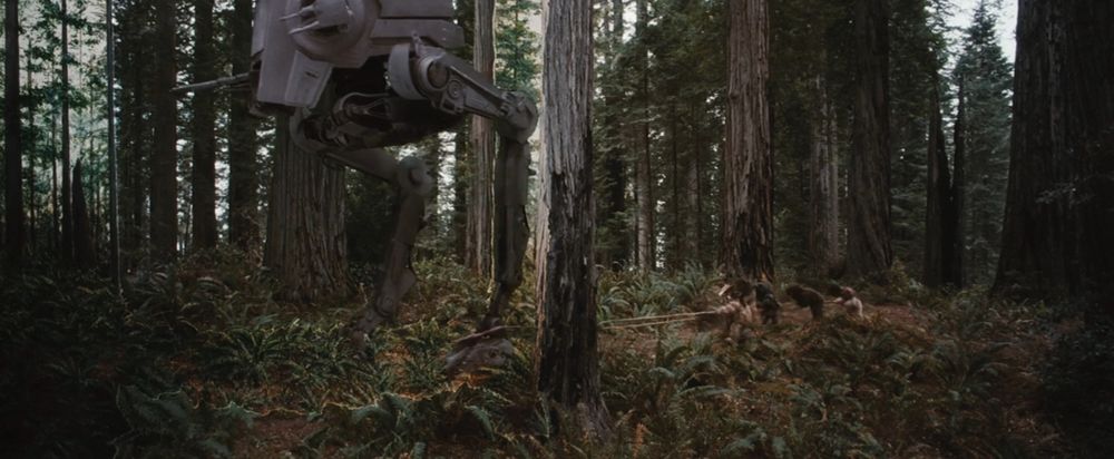 A screencap from Return of the Jedi where a group of Ewoks have looped a rope around an AT-ST's foot to try to stop it...