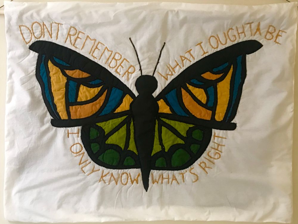 A quilted butterfly on a white background. The text surrounding the butterfly reads "Don't remember what I oughta be, I only know what's right"