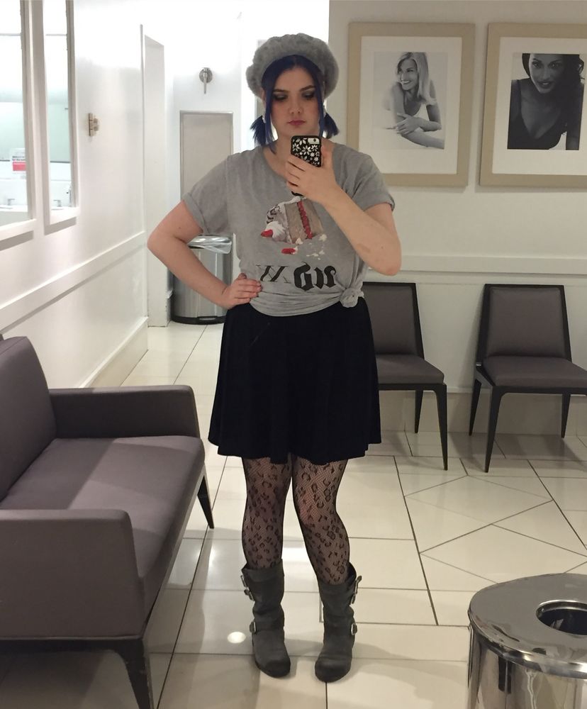 Mirror shot of Manda. Royal blue hair center pair and pig tails under gray beret. Gray Urban Decay shirt, black skirt, black fishnets and gray boots