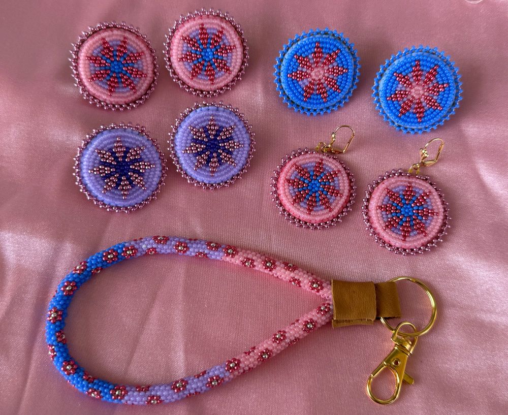 4 pairs of beaded circular earrings: 2 pink, 1 purple, 1 blue. One peyote stitch wristlet in blue, purple and pink ombré design with pink metallic flowers. 