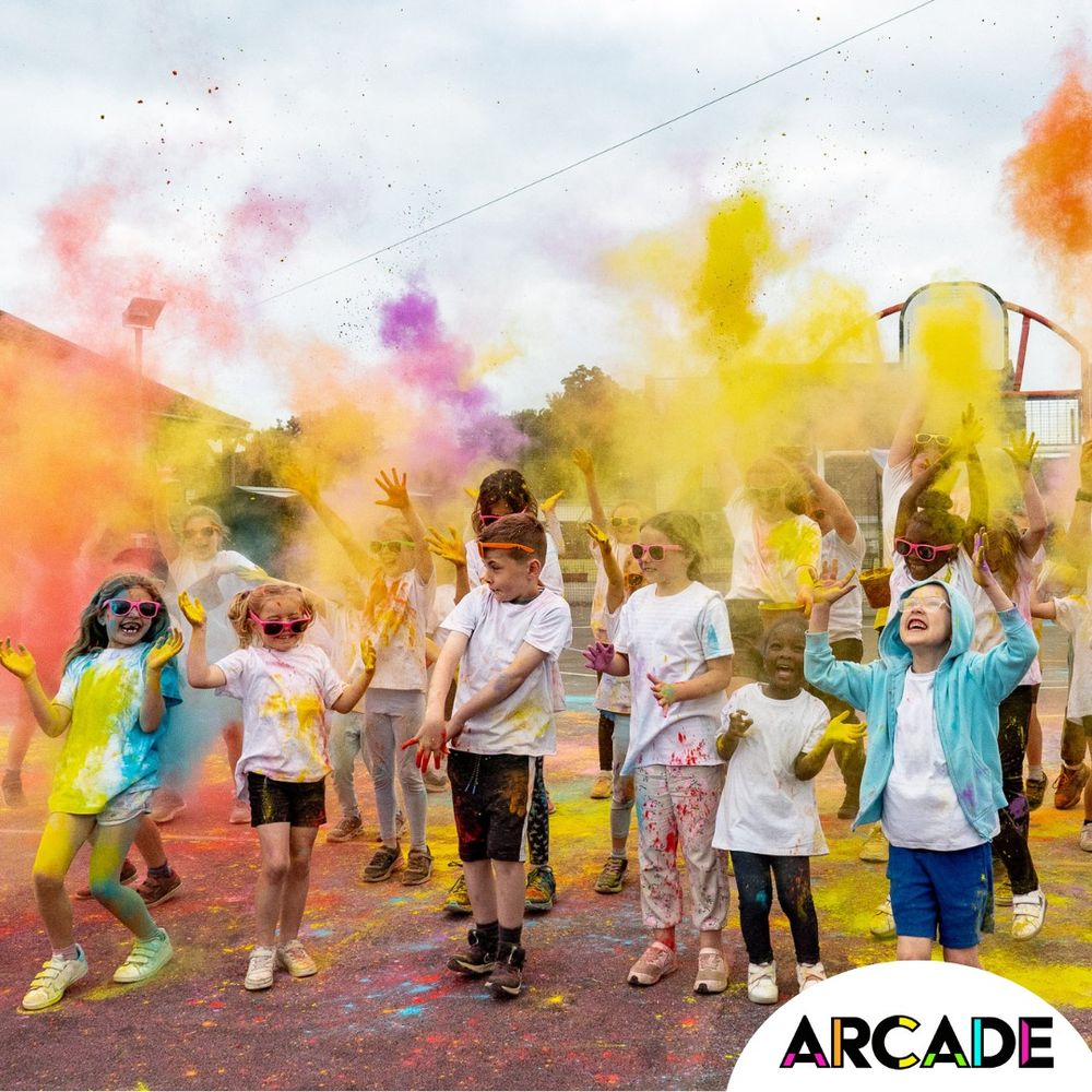Children are throwing brightly coloured paint powder and looking very joyful