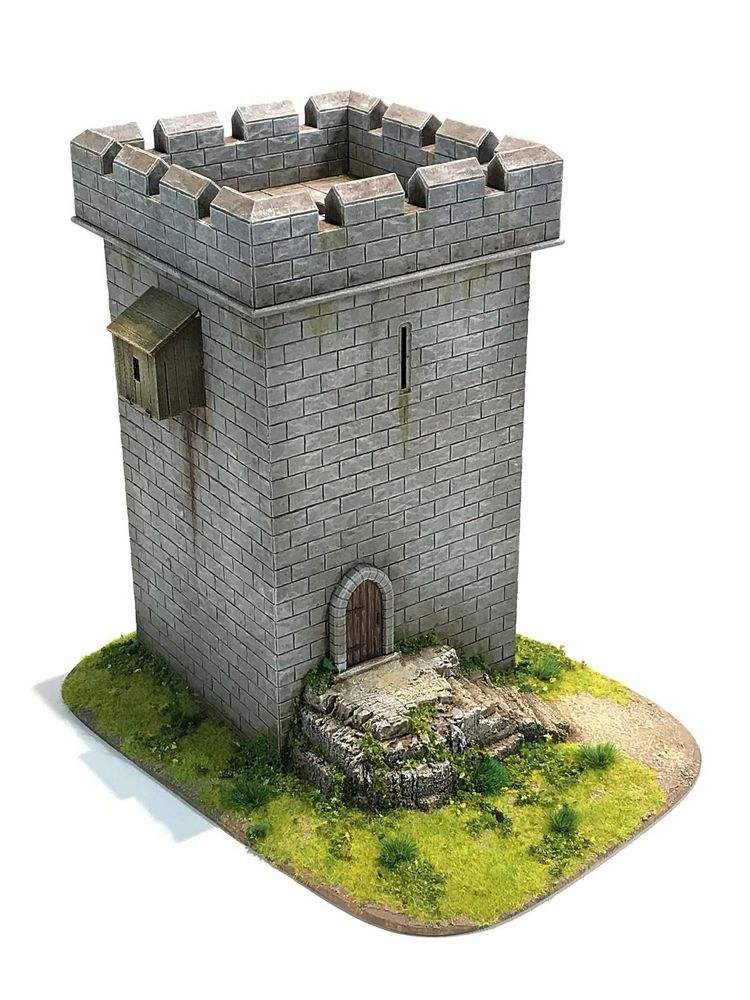 A lone, battlemented, castle tower on a scenic base with a small rock outcrop leading to a door