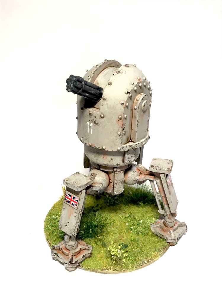 A three legged VSF walker painted grey on a green, temperate base. It has the union flag on its legs and the № ‘11’ on its ‘torso’. 
