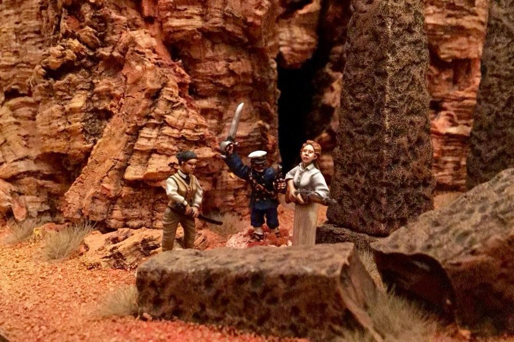 Three of our game characters stand in front of a ruined temple entrance deciding who’s going to go in first. 