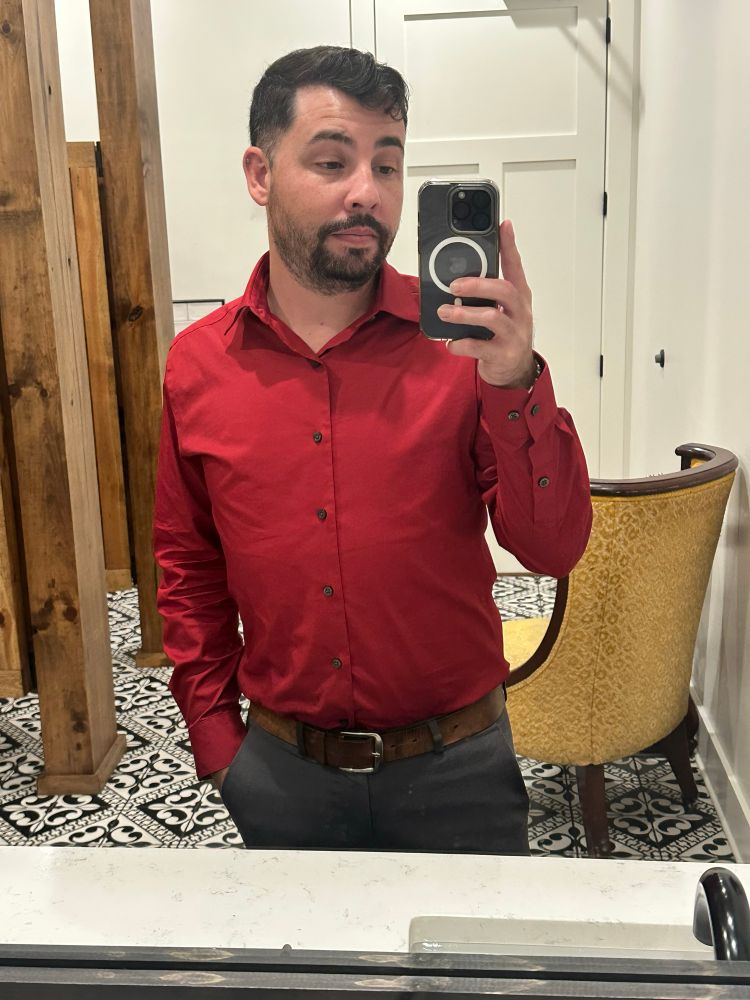Bathroom selfie of me wearing a red shirt at a wedding. 