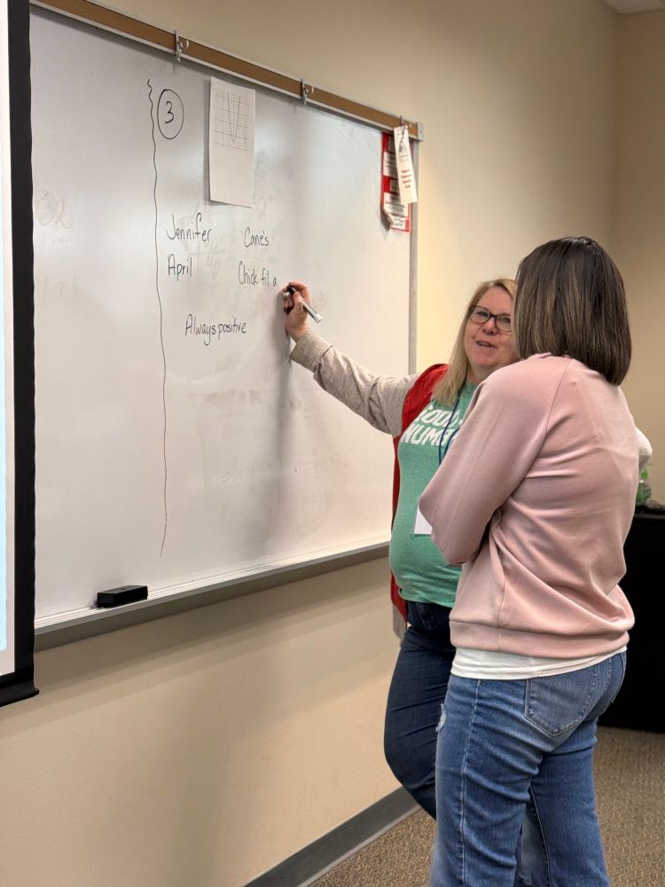 Two students at a whiteboard.