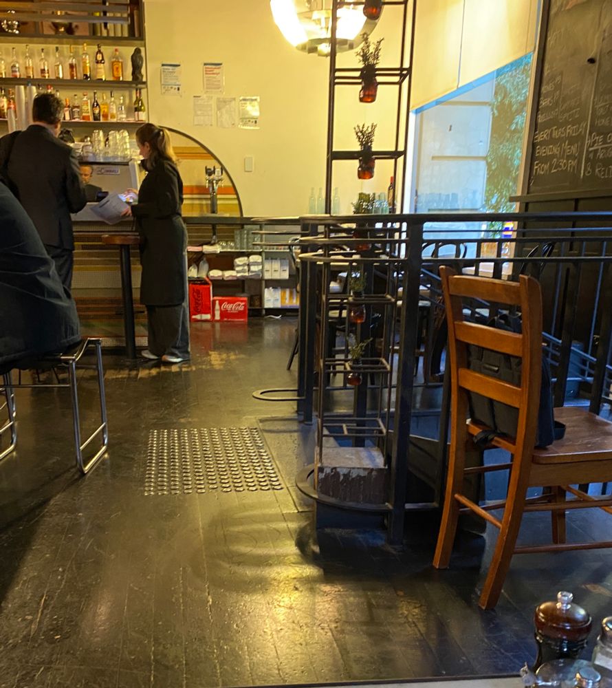 Interior of Jounal Cafe, dark wood, soft lighting. 