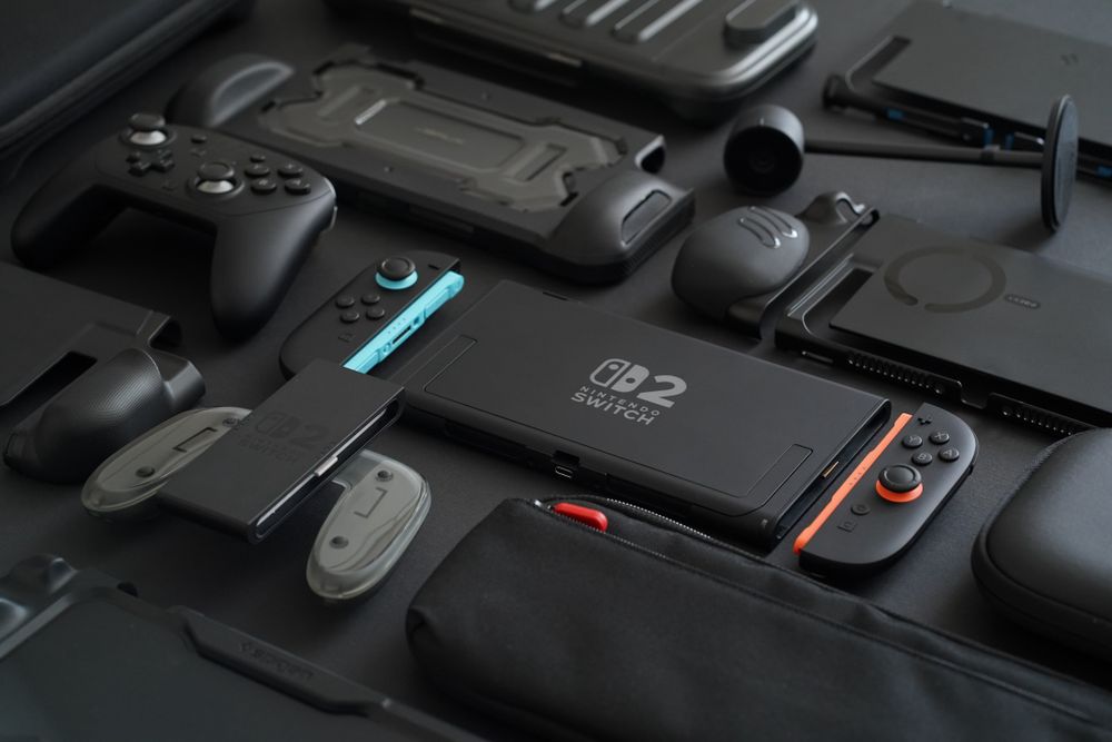 Nintendo Switch 2 cases, grips, controllers, and accessories laying flat on a soft black background