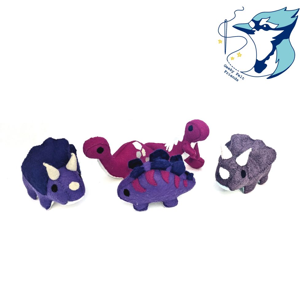 A photo of several plush baby dinosaurs of different species, in purple and pink