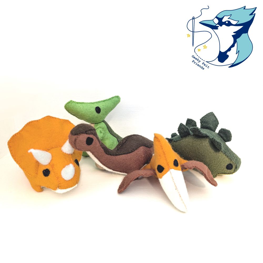 A photo of five baby dinosaur plushies made to look like the main cast of the land before time
