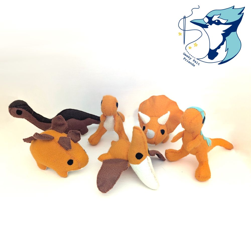 A photo of several plush dinosaurs of different species, mostly in orange
