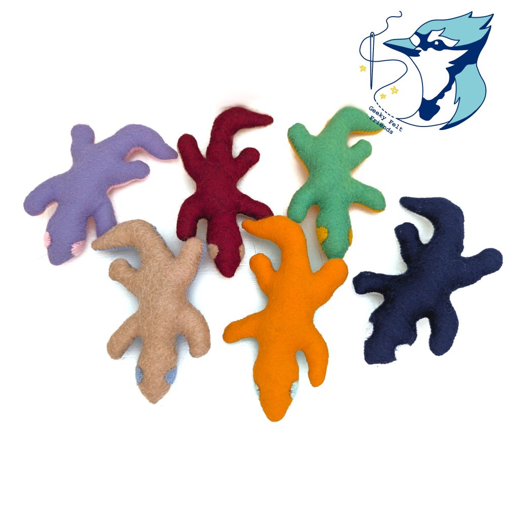 A photo of six simple lizard plushies on various colors