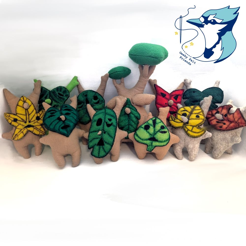 A photo of a collection of plushies, the Koroks from the legend of Zelda, little tree creatures with leaf masks.