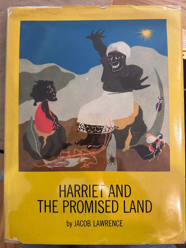 Harriet and the Promised Land by Jacob Lawrence, an old hardcover book featuring a painting of a Black woman telling a story to a Black child 