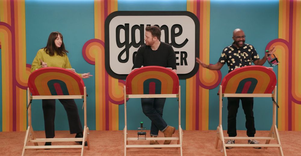Three people playing bingo on a game show 