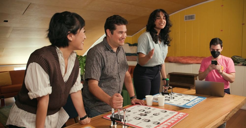 three people watching three people playing bingo on a game show, playing bingo on a game show