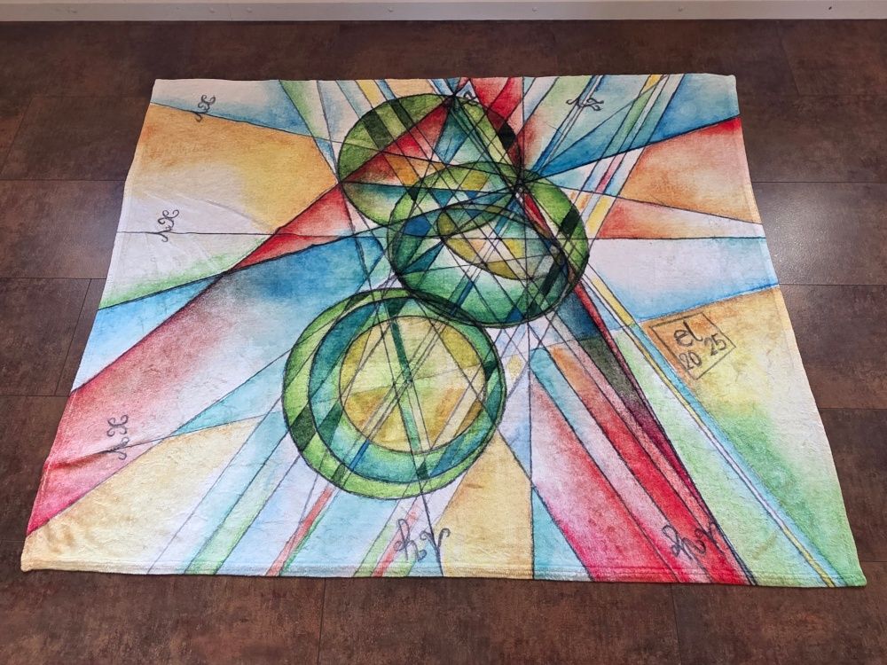 Photo of a throw blanket with mathematical art laid out flat the floor (tiles in rusty metal design) of a room. 50in × 60in fluffy shiny blanket printed with reproduction of traditional manual geometrical construction originally created with watercolor pencils on paper. Colored in the style of stained glass, main colors in the drawing: Orange, yellow, light green, dark green. Created by elkement 2025.
