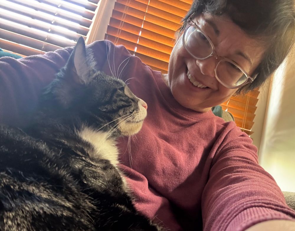 My wife Lisa taking a selfie with our cat Oliver on her lap - Oliver is looking at her with cat adoration