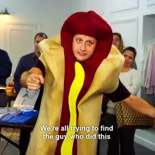 Scene from I Think You Should Leave of Tim Robinson in hot dog costume with caption “We’re all trying to find the guy who did this”
