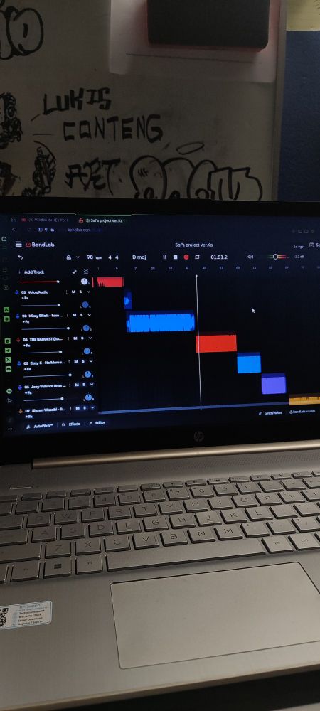 A laptop with music editing software on it